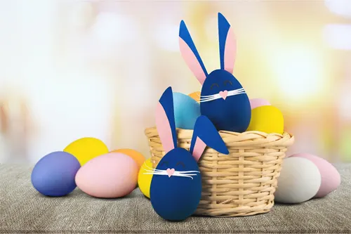 easter bunny decorated eggs in a basket